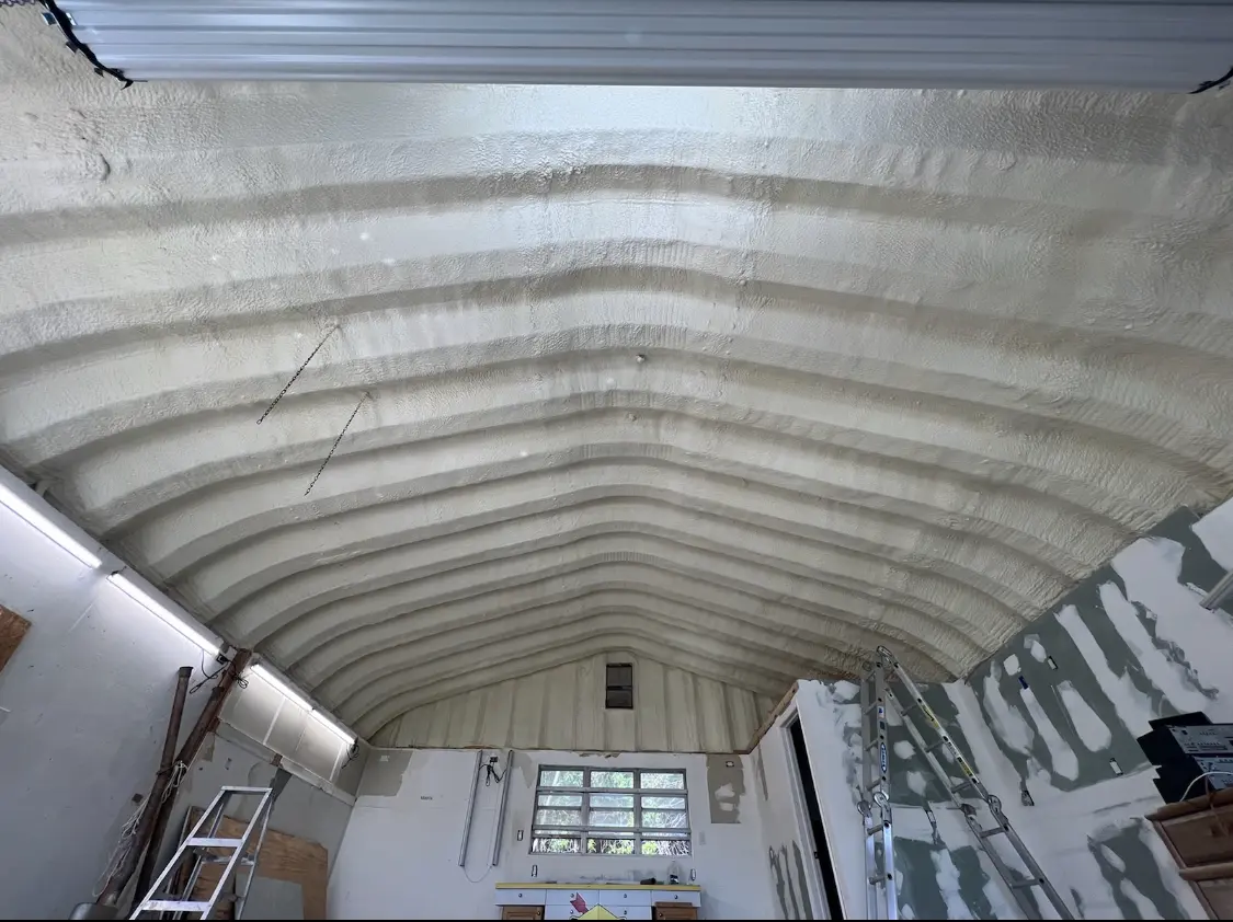 Spray polyurethane foam applied to the underside of a metal roof deck in Balm
